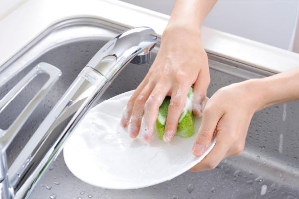 Washing dishes by hand kitchen sink